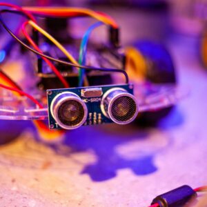 Detailed view of a robotic vehicle component showcasing wires and sensors.