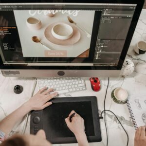 Overhead view of a creative workspace with design tools and sketches visible, ideal for teamwork and collaboration.