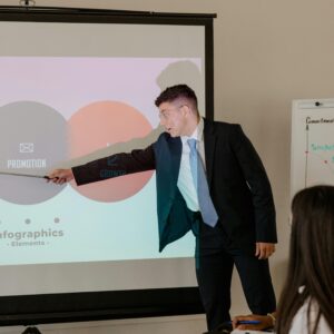 Professional giving presentation using infographic in an office meeting.